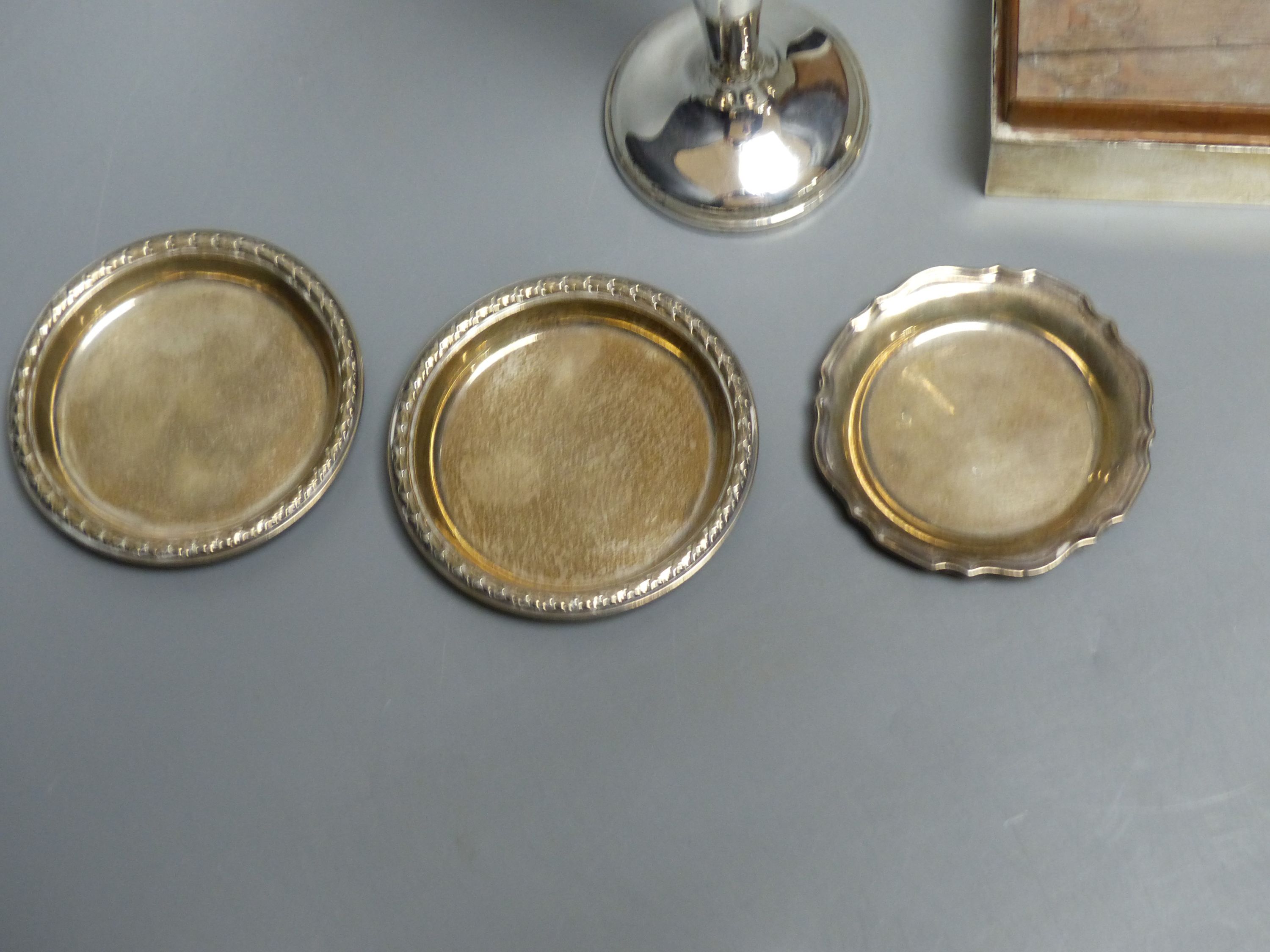 An engine-turned silver cigarette box, a pair of circular pin dishes, another pin dish and a specimen vase